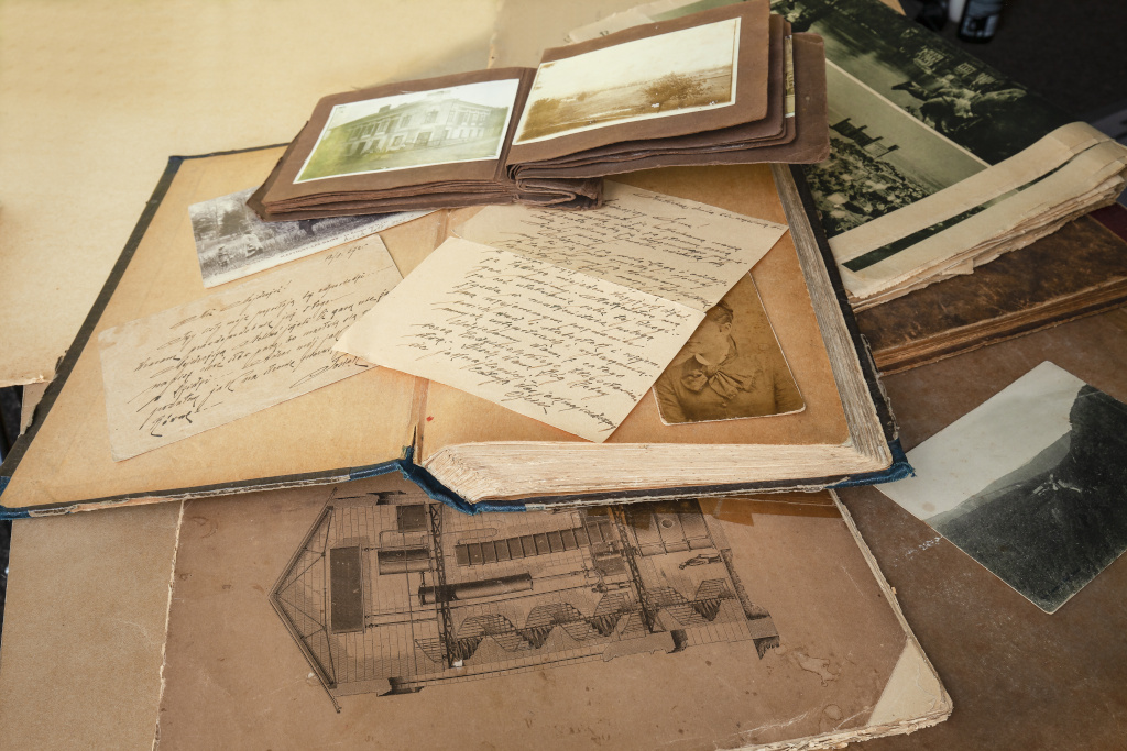 Image of old postcards, letters and atlas